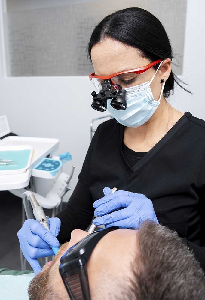 Patient receiving deep gum cleaning scaling and root planing treatment with numbing for comfort in North Miami Beach FL Dental Pearl Miami