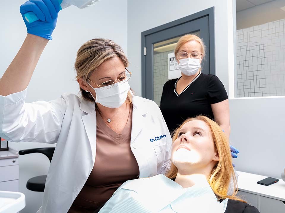 Dentist performing a comprehensive dental checkup exam at Dental Pearl in North Miami Beach on Biscayne Blvd, evaluating teeth, gums, and overall oral health