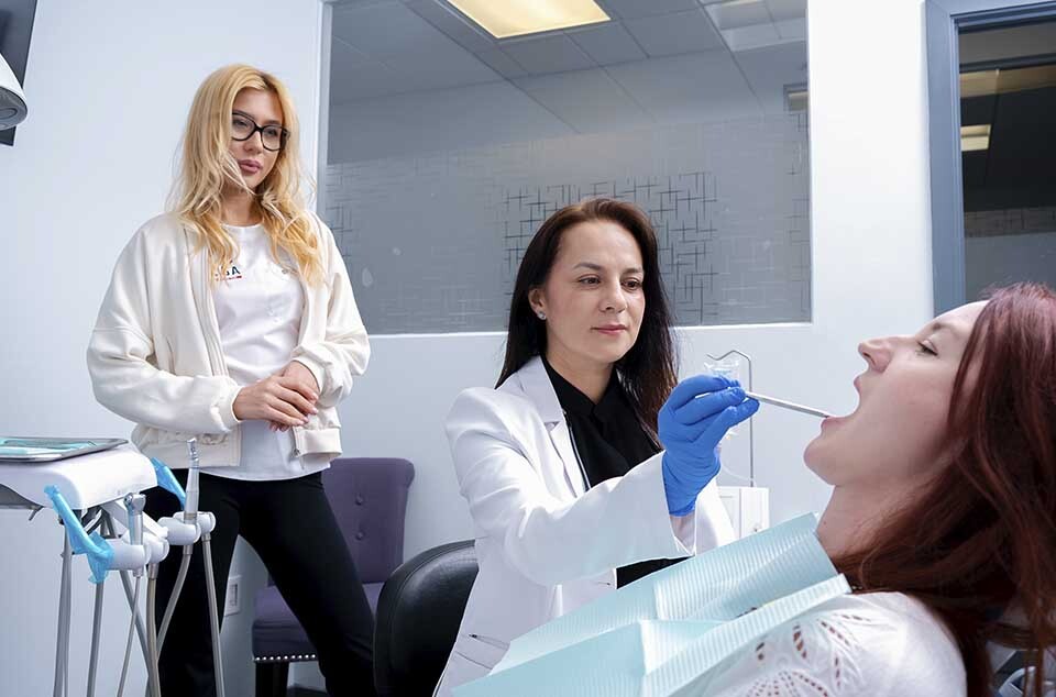 Dentist performing dental crown procedure steps including tooth preparation and impression at Dental Pearl Miami in North Miami Beach FL