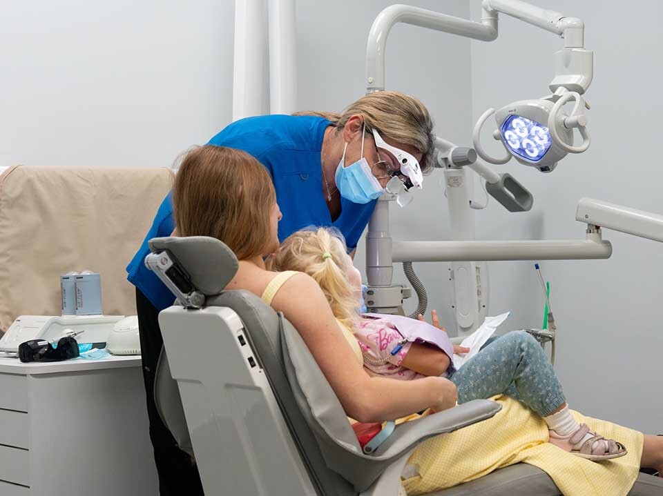Family dentist treating child with parent present in North Miami Beach FL at Dental Pearl Miami