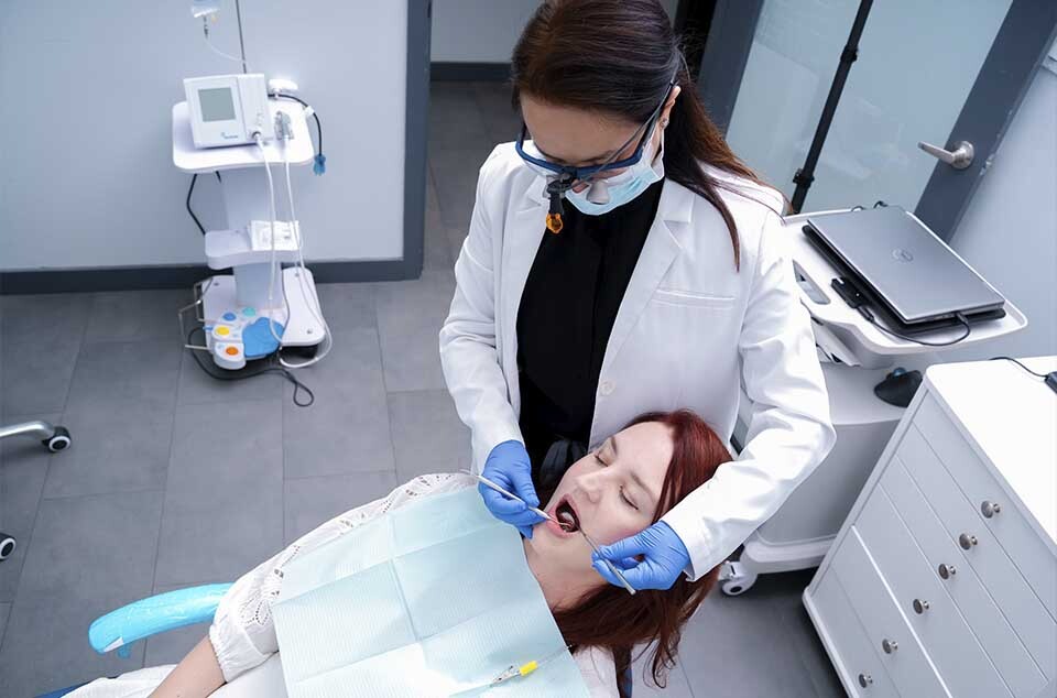 Dentist performing visual examination to diagnose tooth decay in North Miami Beach FL at Dental Pearl Miami