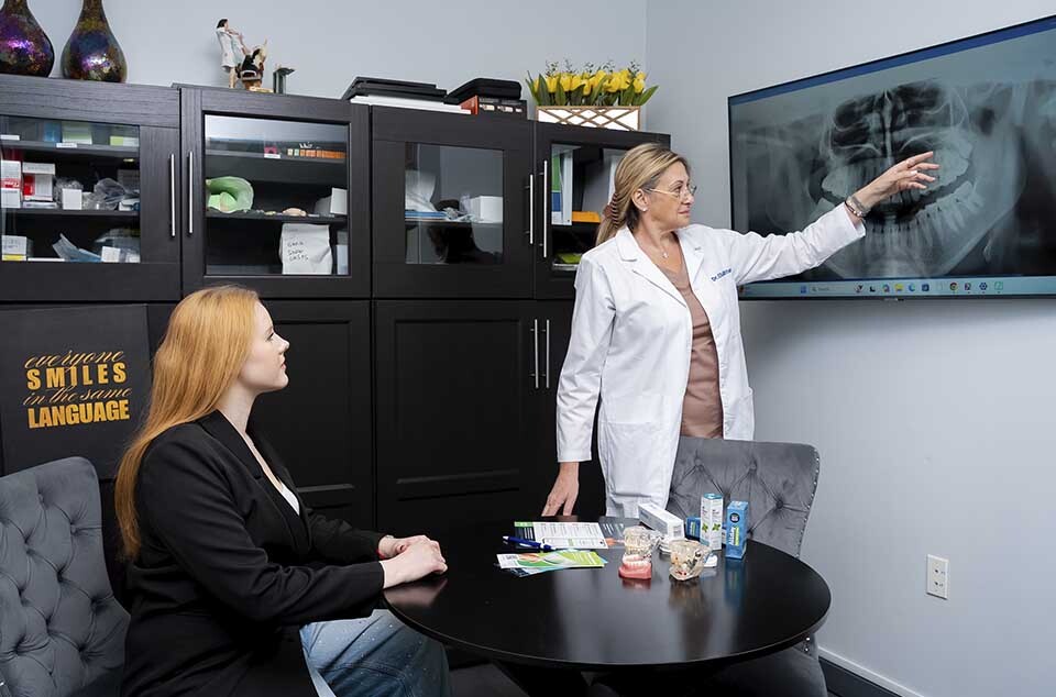 dentist reviewing dental xray with patient to diagnose teeth grinding bruxism in North Miami Beach FL