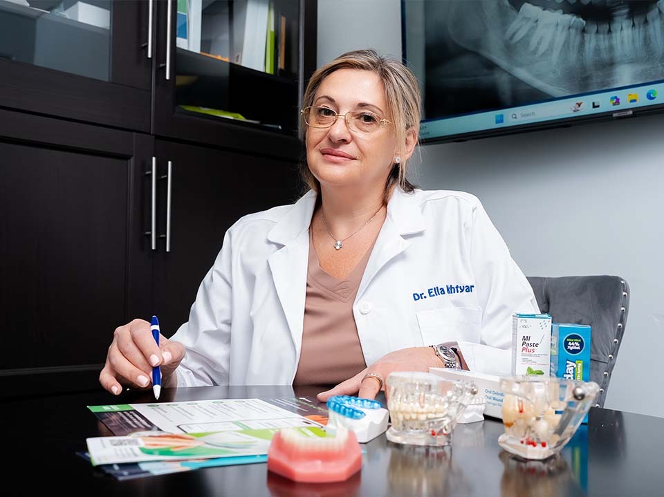 dentist providing gentle dental care for senior patient in North Miami Beach FL at Dental Pearl Miami