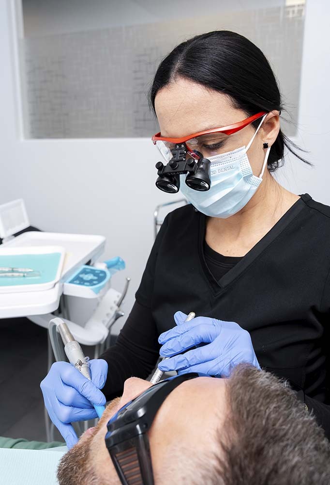 Dentist performing emergency root canal treatment using precision tools at Dental Pearl Miami in North Miami Beach FL