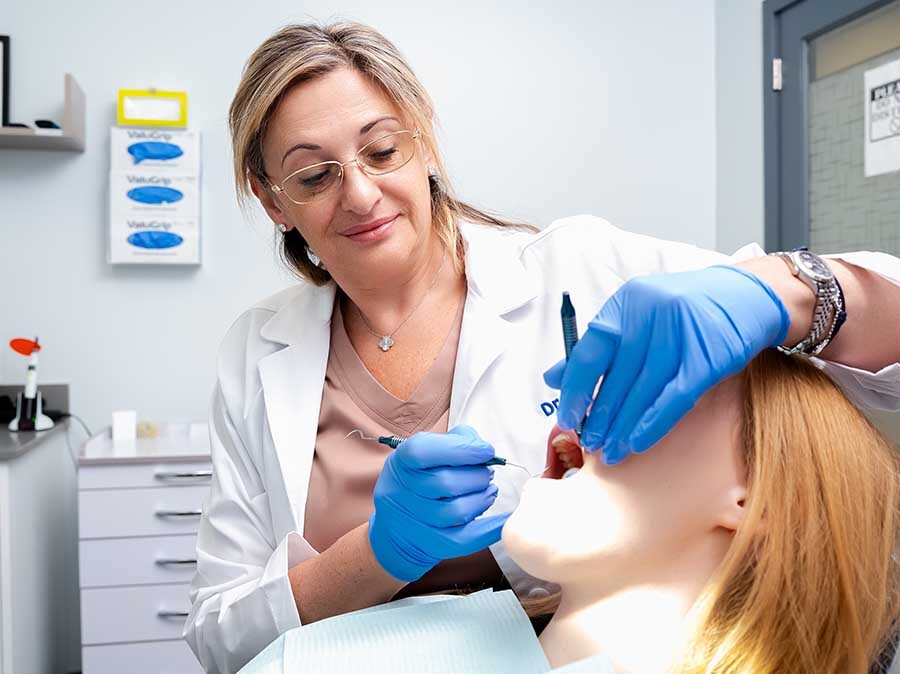 Periodontist performing detailed gum examination and periodontal treatment at Dental Pearl Miami in North Miami Beach FL