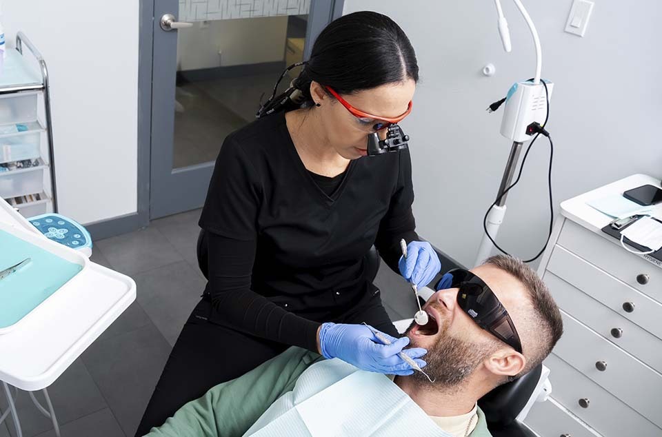Dentist performing root canal therapy at Dental Pearl North Miami Beach FL demonstrating precise endodontic treatment
