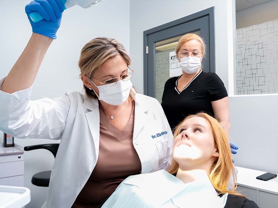 dentist examining patient for teeth grinding bruxism in North Miami Beach FL at Dental Pearl Miami