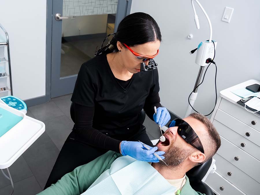 Dentist performing tooth extraction procedure at Dental Pearl Miami in North Miami Beach FL ensuring safe and comfortable oral surgery care