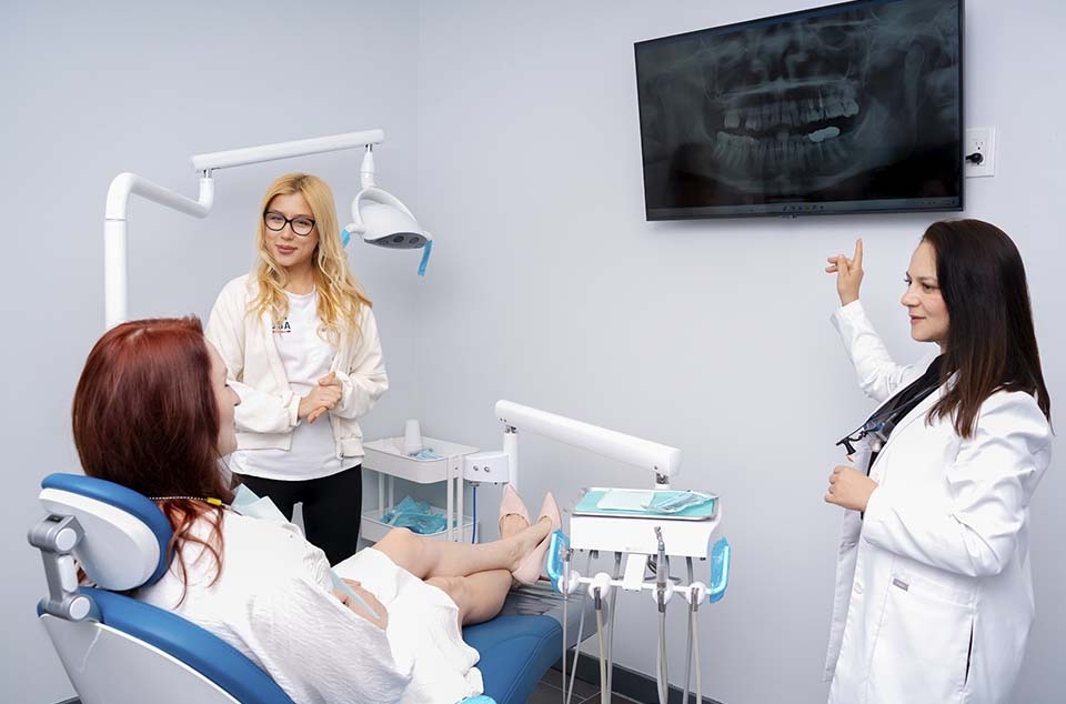 dentist reviewing dental xray with patient to diagnose tooth infection in North Miami Beach Florida