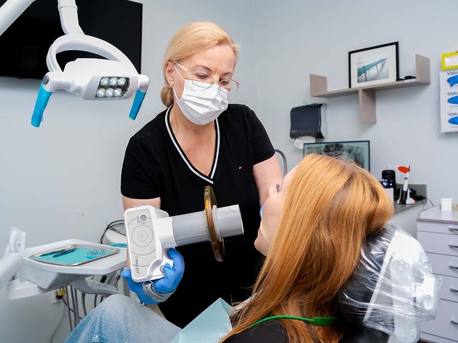 dentist examining patient to diagnose tooth pain in North Miami Beach FL at Dental Pearl Miami