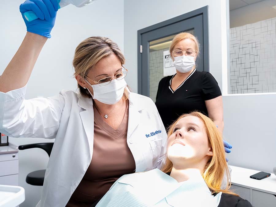 dentist performing wisdom teeth evaluation and oral exam at Dental Pearl Miami in North Miami Beach FL
