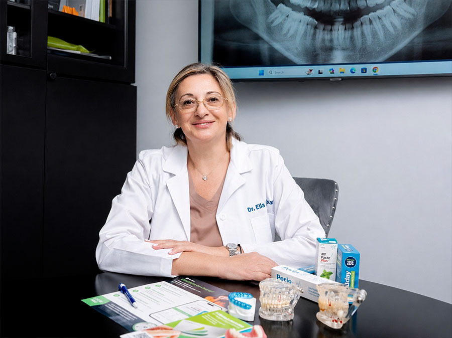 Dentist examining gums for periodontal disease at Dental Pearl in North Miami Beach on Biscayne Blvd to detect infection and gum recession