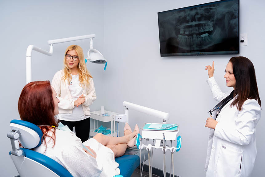 Dentist reviewing dental X-ray during mini dental implant planning at Dental Pearl in North Miami Beach